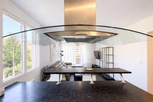 a dining room with a table and a large window at M031 Joli t3 centre d'Annemasse in Annemasse +6 photos