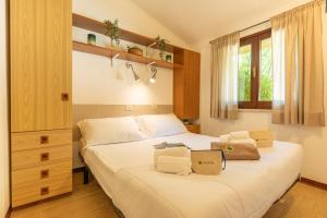 a bedroom with a bed with two bags on it at Club del Sole La Risacca Family Collection in Porto SantʼElpidio +143 photos