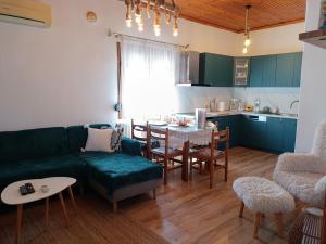 a living room with a green couch and a table at Rooster Retreat in Aridaia