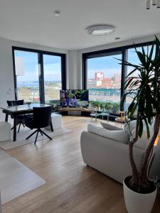 a living room with a couch and a table at DeLux Apartment Koper - NEW in Koper
