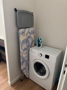 a washing machine with a tv on top of it at Maison Colonel Teyssier in Albi