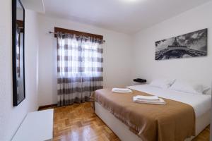 a bedroom with a bed and a window with the eiffel tower at Gerês Home Nature in Geres