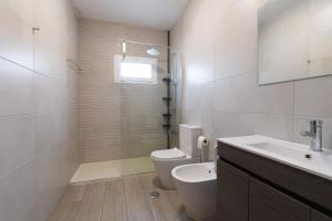 a bathroom with a toilet and a sink and a shower at Gerês Home Nature in Geres +16 photos