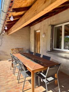a wooden table and chairs on a patio at Maison Colonel Teyssier in Albi