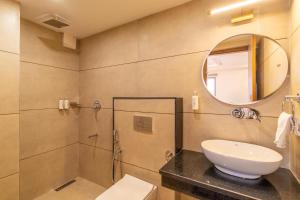 a bathroom with a shower and a toilet and a sink at goSTOPS Plus Katra in Katra