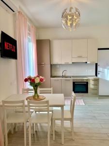 a kitchen and dining room with a table and chairs at The Sea Pearl Suite in Punta Marina +2 photos