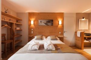 a bedroom with a large white bed with two pillows at Maison Seignou in Azet