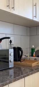 a kitchen with a counter top with a microwave at Private apartment beach resort in Hurghada