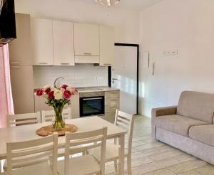 a living room with a table with a vase of flowers at The Sea Pearl Suite in Punta Marina