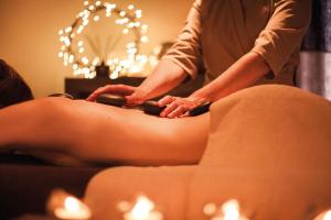 a woman getting a massage from a therapist at Maison Seignou in Azet