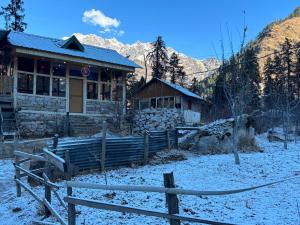 a house with a fence in front of it at EcoGlampLife in Kalgha +18 photos