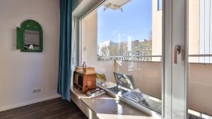 a living room with a window and a tv at Spacious Flat 2nd Floor near station in Karlsruhe