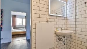 a bathroom with a sink and a mirror at Spacious Flat 2nd Floor near station in Karlsruhe +29 photos