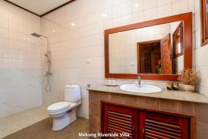 a bathroom with a toilet and a sink and a mirror at Mekong Riverside Villa in Vientiane +121 photos