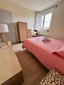 a bedroom with a red bed and a window at Maison Colonel Teyssier in Albi