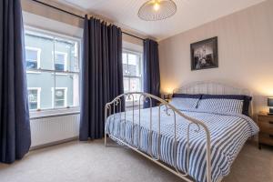 a bedroom with a bed and a window at Pump House Apartments in Derry Londonderry