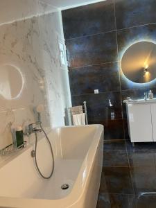 a bathroom with a bath tub and a sink at Villa Vlamari in Vathý