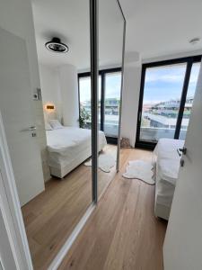 a bedroom with two beds and a mirror at DeLux Apartment Koper - NEW in Koper +18 photos