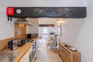 a kitchen with a counter top and a stove top oven at Pump House Apartments in Derry Londonderry