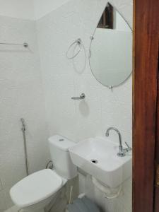 a bathroom with a toilet and a sink and a mirror at Praia Jeri House in Jericoacoara +51 photos