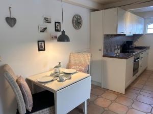 a kitchen with a table with plates on it at Lykke in Wrixum