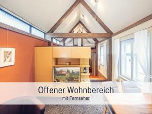 an open living room with a fireplace in a house at Dolly Dur - Mini Ferienhaus in Kyritz, einer charmanten Stadt im Herzen von Brandenburg in Kyritz