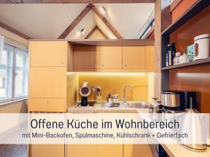 a kitchen with yellow cabinets and a sink at Dolly Dur - Mini Ferienhaus in Kyritz, einer charmanten Stadt im Herzen von Brandenburg in Kyritz +30 photos
