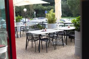 a row of tables and chairs with plants on them at Hotel Galaxie in Zlín