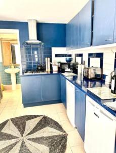 a kitchen with blue cabinets and a counter top at St Leonards in Hollington