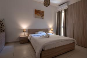 a bedroom with a large bed and a window at Bayview Seafront 5A in St. Julianʼs