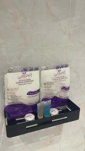 two towels and two glasses on a shelf at غرفتين وصالة بدخول ذكي in Al Kharj