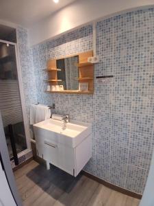 a bathroom with a white sink and a mirror at Hôtel Quai d'Azur in Le Grau-du-Roi +182 photos