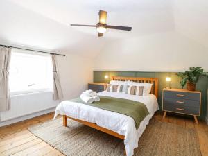 a bedroom with a bed with a stuffed animal on it at Vintner's Cottage in Norwich