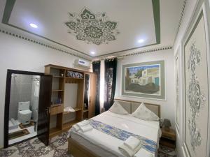 a bedroom with a bed and a chandelier at Gavhar Boutique Hotel in Khiva
