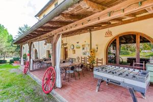 a house with two ping pong tables on a patio at Agriturismo Girasole in Gambassi Terme