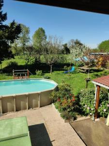 a swimming pool in the middle of a yard at Au Jardin d'Isa in La Résie-Saint-Martin