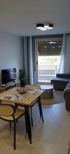 a living room with a wooden table and chairs at Pont de Ferro Sunny Flat - Mediterránea Sunny Keys in Benicàssim