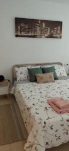 a bed sitting in a room with a white wall at Pont de Ferro Sunny Flat - Mediterránea Sunny Keys in Benicàssim