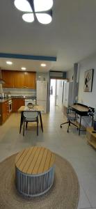 a living room with a table and a kitchen at Pont de Ferro Sunny Flat - Mediterránea Sunny Keys in Benicàssim +8 photos