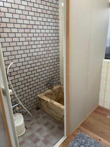 a bath tub in a bathroom with a toilet at 和の宿 禅 in Nachikatsuura +54 photos