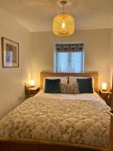 a bedroom with a large bed and a window at Crymlyn barn in Llanwrda