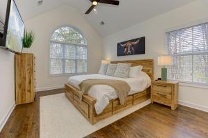 a bedroom with a large bed and a flat screen tv at Lake Vista Lodge in Jasper +70 photos