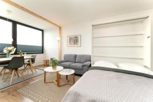 a bedroom with a bed and a table and a couch at Marina Wendtorf Oase in Wendtorf