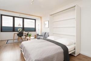 a bedroom with a bed and a couch at Marina Wendtorf Oase in Wendtorf