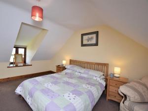 a bedroom with a bed and a chair and a mirror at 2 Bed in Mold oc-41656 in Caerwys