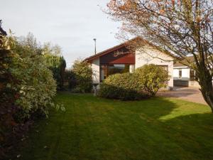 a house with a green lawn in front of it at March Brown in Garmouth