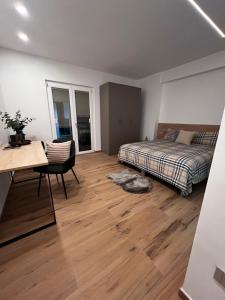 a bedroom with a bed and a desk and a table at Mood Valentina in Goriano Sicoli