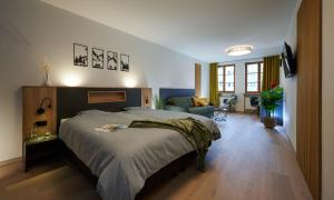ein Schlafzimmer mit einem großen Bett und ein Wohnzimmer in der Unterkunft Unser Hotel in Eggenfelden