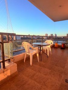 two chairs and a table on a balcony with a view at Puerto Amarras Apartment in Santa Fe