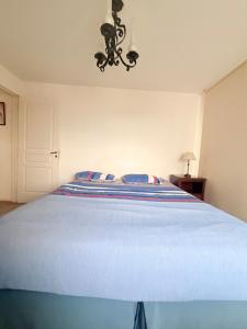 a bedroom with a bed with a blue comforter at Puerto Amarras Apartment in Santa Fe +17 photos